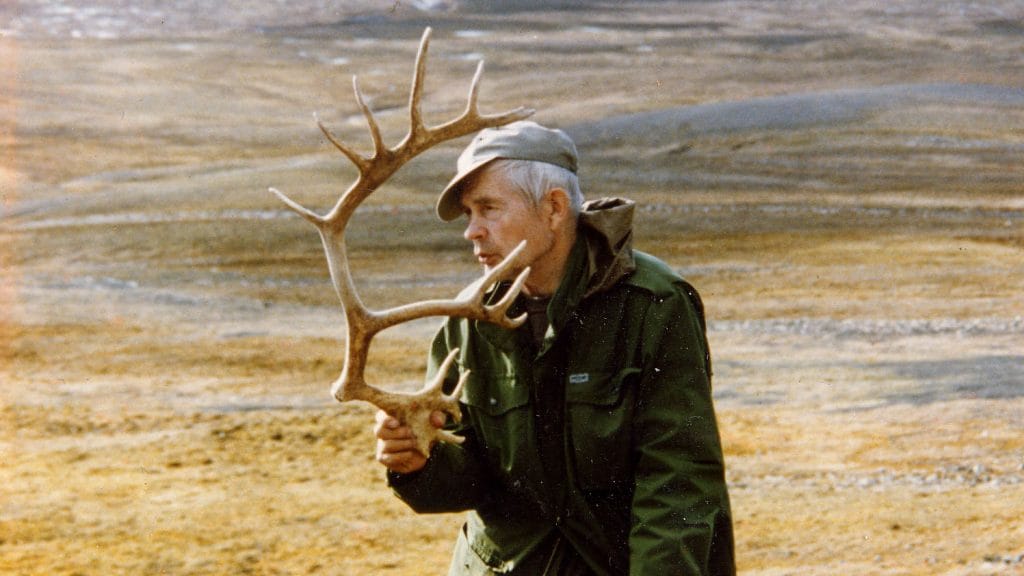 Salkio holds a cast antler in his hand fell scenery behind.