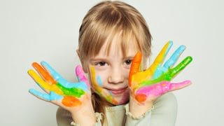 a child hands in finger paints